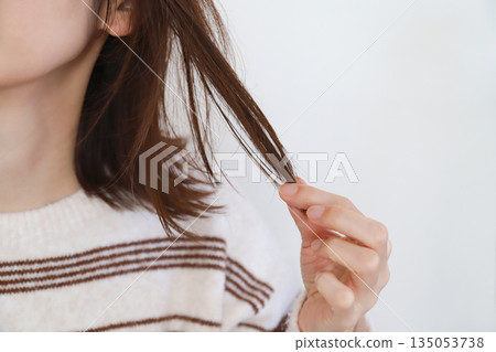 Hair care for women touching their hair 135053738