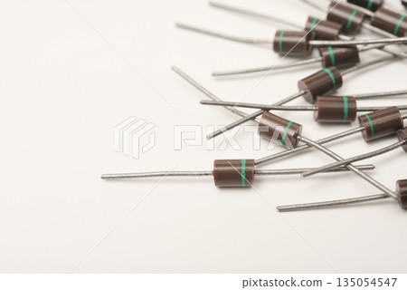 An old diode on a white background. Electronic elements. Electronic diodes. An old diode on a white background. Electronic elements. Electronic diodes. 135054547