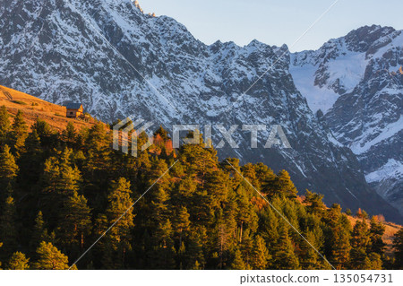 small cabin is perched on a hillside, surrounded by high mountains small cabin is perched on a hillside, surrounded by high mountains 135054731