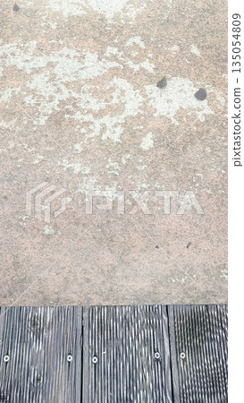 High angle view of autumn leaves floating in clear water next to a grey wooden deck in a garden High angle view of autumn leaves floating in clear water next to a grey wooden deck in a garden 135054809