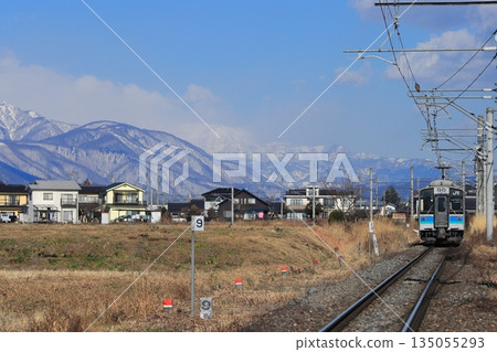 The Oito Line E127 series train runs leisurely under the watchful eye of the beautiful Northern Alps. Photo taken on December 7, 2025. 135055293