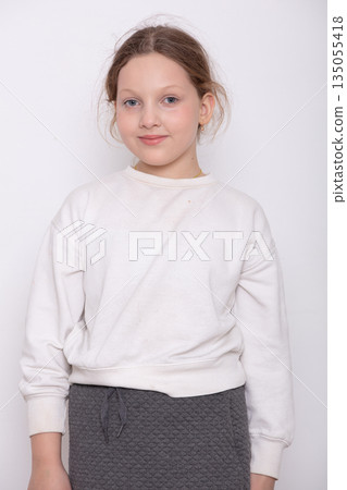 Young girl poses for a casual portrait in a simple outfit 135055418