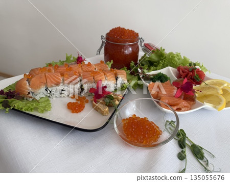 Premium salmon sashimi donburi featuring ikura salmon roe, caviar, and raw egg yolk, elegantly presented with wasabi and pickled ginger on a white background. Premium salmon sashimi donburi featuring ikura salmon roe, caviar, and raw egg yolk, elegantly presented with wasabi and pickled ginger on a white background. 135055676
