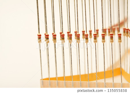 Packaging of film resistors. Resistors with axial terminals.  Yellow resistors in the package. 135055838