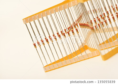 Packaging of film resistors. Resistors with axial terminals.  Yellow resistors in the package. 135055839
