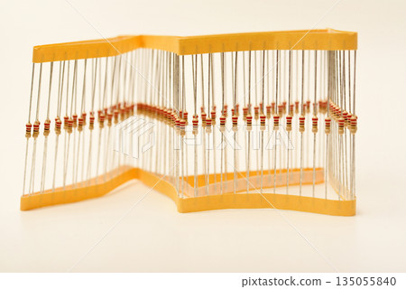 Packaging of film resistors. Resistors with axial terminals. Yellow resistors in the package. Packaging of film resistors. Resistors with axial terminals. Yellow resistors in the package. 135055840
