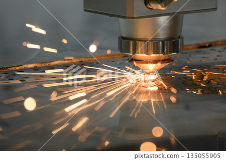 Close up scene the fiber laser cutting machine cut the metal plate control by CNC program. 135055905