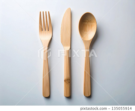 Eco friendly. Set of eco-friendly bamboo cutlery: wooden spoon, fork and knife on a white background. 135055914