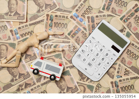 A fallen doll, an ambulance, a calculator, and a pile of 10,000 yen bills A fallen doll, an ambulance, a calculator, and a pile of 10,000 yen bills 135055954