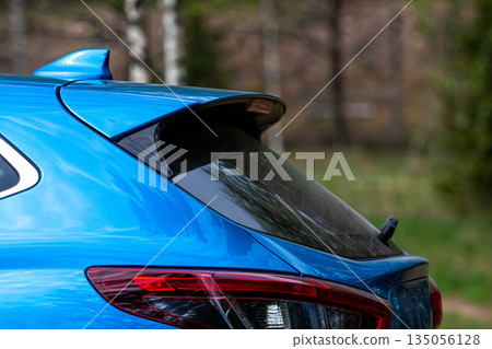 Detail of a blue sports car in the forest. Selective focus 135056128