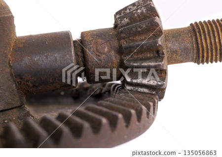 Detail of an old machine gear on a white background Detail of an old machine gear on a white background 135056863