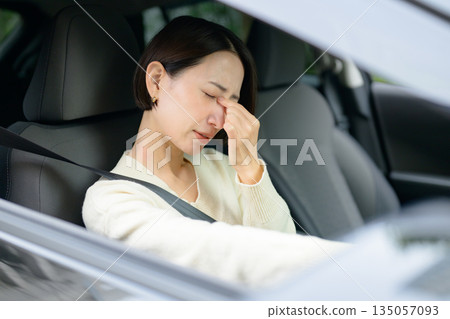 A woman feeling tired in the car 135057093