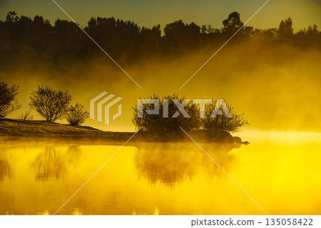Morning fog over autumn lake water 135058422