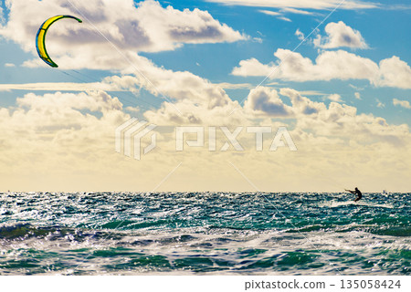 Kite surfer riding waves. Kiteboarding sport. Kite surfer riding waves. Kiteboarding sport. 135058424