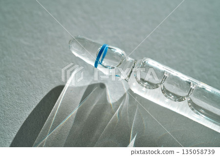 Ampoule with blue ring containing healthcare medicine Ampoule with blue ring containing healthcare medicine 135058739