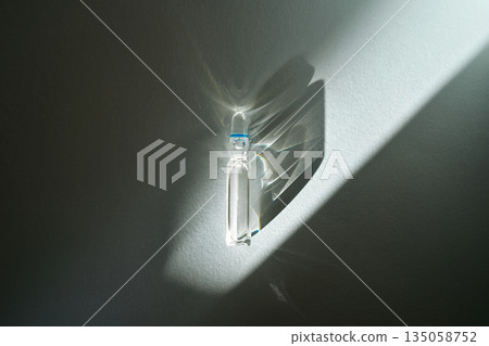 Ampoule with medication casting shadows for health treatment Ampoule with medication casting shadows for health treatment 135058752