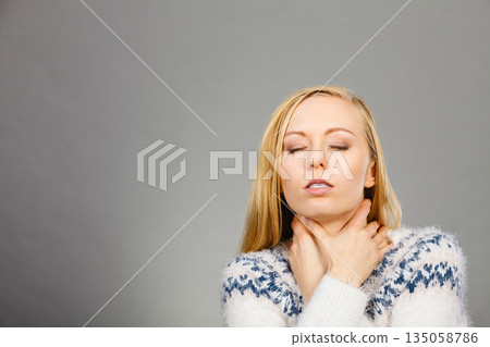 Woman having sore throat feeling pain Woman having sore throat feeling pain 135058786