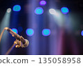 Microphone against blue stage lights. Beams from concert spotlights illuminate the microphone. 135058958