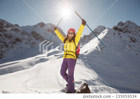 Woman Standing on Top of Snow Covered Slope Woman Standing on Top of Snow Covered Slope 135059334