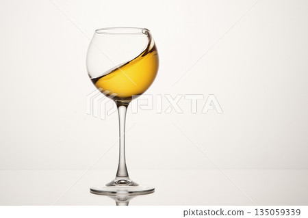 White wine diagonal wave, curl is in stemmed glass. White wine diagonal wave, curl is in stemmed glass. 135059339