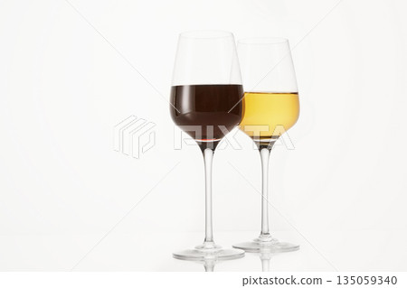 Two wineglasses half filled with red and white wine. Two wineglasses half filled with red and white wine. 135059340