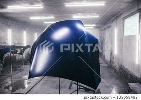 Car parts drying after final painting. Professional painted of automobile in paint chamber. Vehicle restoration in the paint garage booth. 135059482
