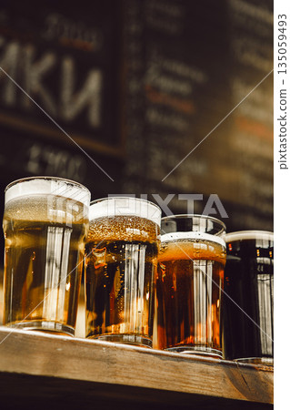 Four Distinct Beers Showcased in Glasses on Bar Counter 135059493