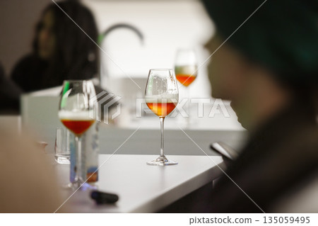 Preparation for Beer Tasting, Poured Alcoholic Drinks to Glasses on Table. Preparation for Beer Tasting, Poured Alcoholic Drinks to Glasses on Table. 135059495
