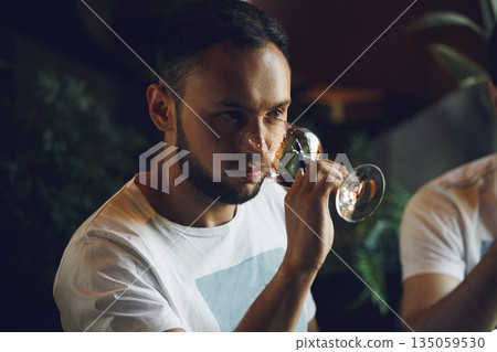 Professional sommelier smell unknown whiskey during blind tasting. Sommelier exam to study different wine and whiskey. Professional sommelier smell unknown whiskey during blind tasting. Sommelier exam to study different wine and whiskey. 135059530