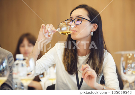Female Sommelier Tasting White Wine Female Sommelier Tasting White Wine 135059543