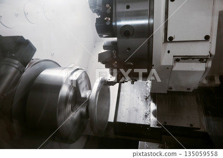 Rotation of aluminium part on CNC metalworking machinery. Working of milling machine with Control Numerical Computer. Rotation of aluminium part on CNC metalworking machinery. Working of milling machine with Control Numerical Computer. 135059558