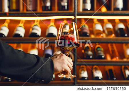 Swirling Dark Red Wine with Cellar Bottles Swirling Dark Red Wine with Cellar Bottles 135059560