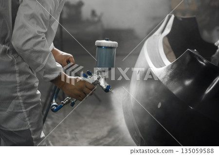 Application of primer before the main spray painting of the car bumper.  135059588