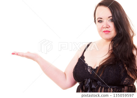 Woman plus size in lingerie holds open hand Woman plus size in lingerie holds open hand 135059597