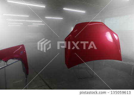 Painted parts of automobile body in auto service. Restoration painting of car in the paint chamber service. Painted parts of automobile body in auto service. Restoration painting of car in the paint chamber service. 135059613