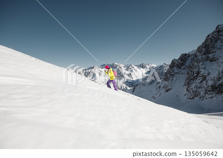 Person Skiing Down Snow Covered Mountain Person Skiing Down Snow Covered Mountain 135059642
