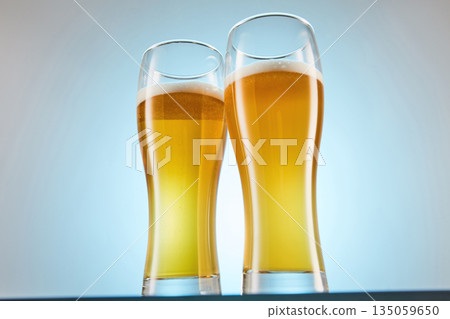 Yellow alcoholic fizzy drink, brew fills glasses to brim. Yellow alcoholic fizzy drink, brew fills glasses to brim. 135059650