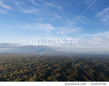 Mountains and forest landscape with blue sky and clouds during day Mountains and forest landscape with blue sky and clouds during day 135059790