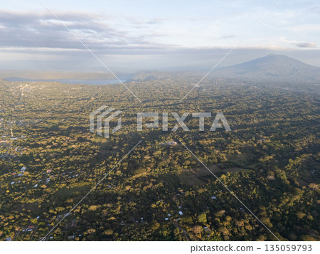 Landscape view of green hills and a mountain in the distance Landscape view of green hills and a mountain in the distance 135059793