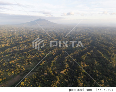 Lush green landscape with mountain view at sunset over hills 135059795