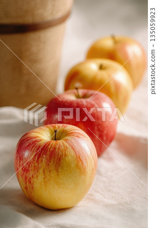 Fresh apple closeup on linen with soft light and bokeh Fresh apple closeup on linen with soft light and bokeh 135059923