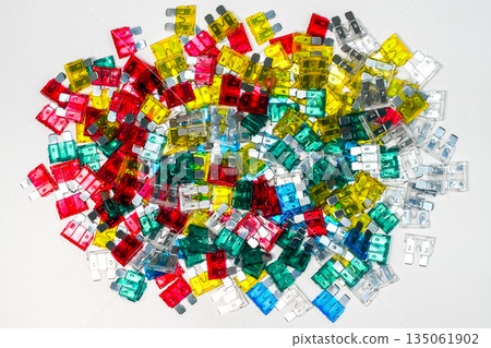 Assorted automotive blade fuses flat lay, colorful standard car fuses on white background Assorted automotive blade fuses flat lay, colorful standard car fuses on white background 135061902