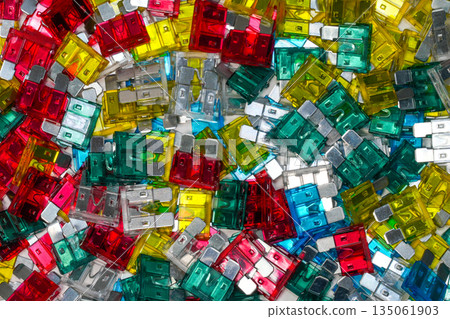 Colorful automotive blade fuses background, assorted standard car fuses flat lay 135061903