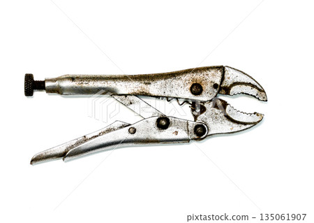 Old locking pliers with worn metal surface on white background, vintage adjustable hand tool 135061907