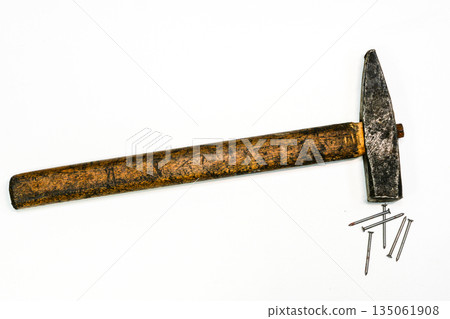 Old carpenter hammer with wooden handle and steel nails on white background, vintage hand tool Old carpenter hammer with wooden handle and steel nails on white background, vintage hand tool 135061908