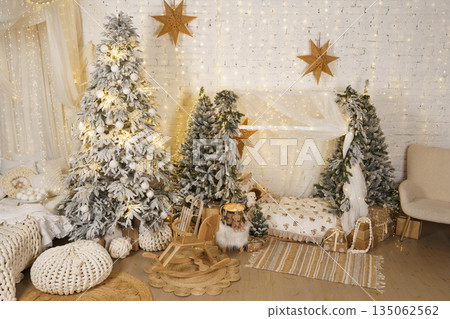 Cozy Scandinavian Christmas kids room with snowy trees, lights and wooden toys 135062562