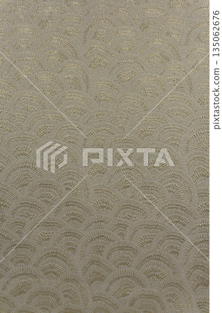 Warm gray-beige brocade fabric texture with wave pattern and yellow metallic lurex, textile collection 135062676