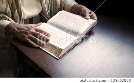 Old man reading a big book 135062998