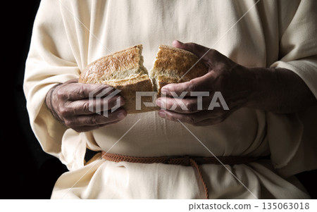 Man's hans holding fresh bread Man's hans holding fresh bread 135063018