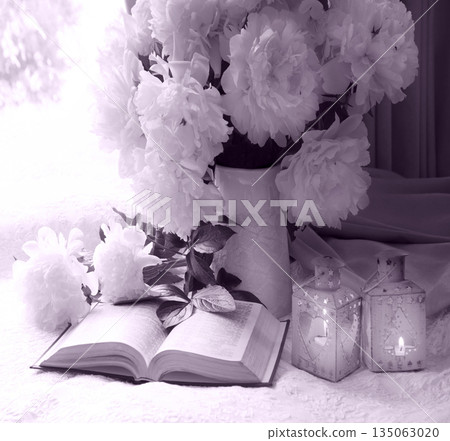 Flowers and book on the table 135063020